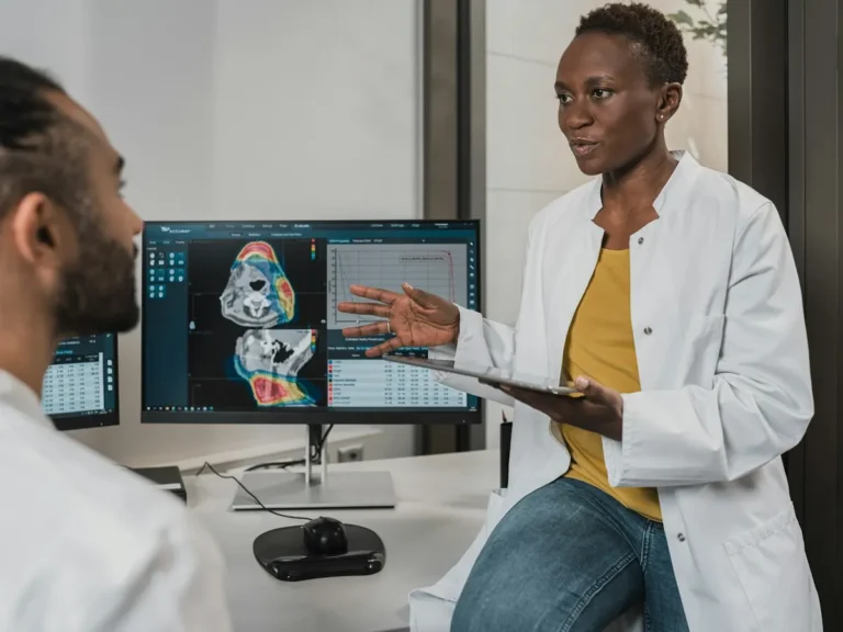 Clinicians reviewing a brain scan on screen